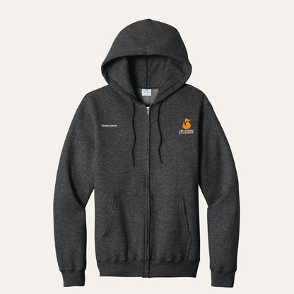 Black Heather adult full-zip hoodie with the orange Lee Autism Academy fox logo on the left chest and a custom name on the right chest